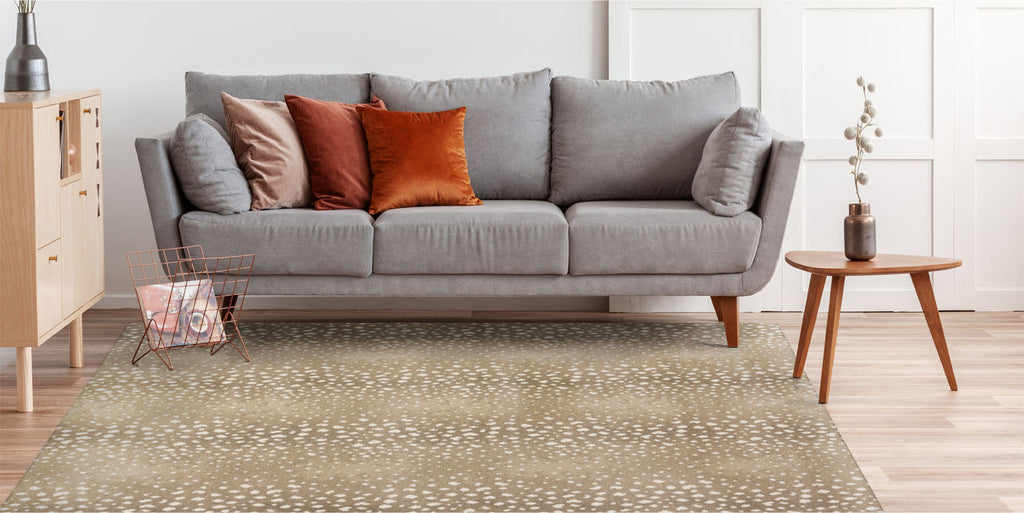 tan rug, grey sofa, orange pillow